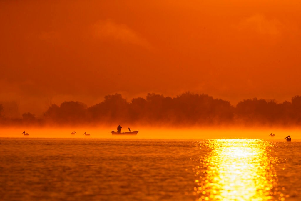 fishing boat morning fog danube delta romania