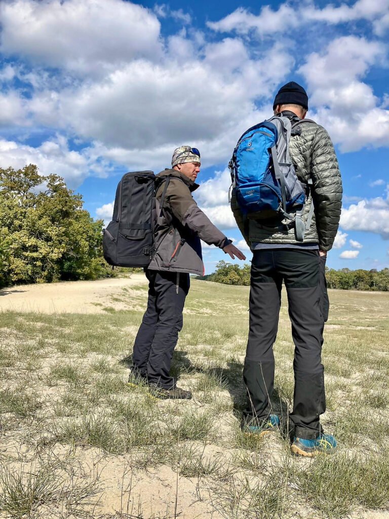 nature guide with guests in open landscape romania