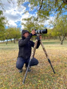 nature photographer in open woodland romania
