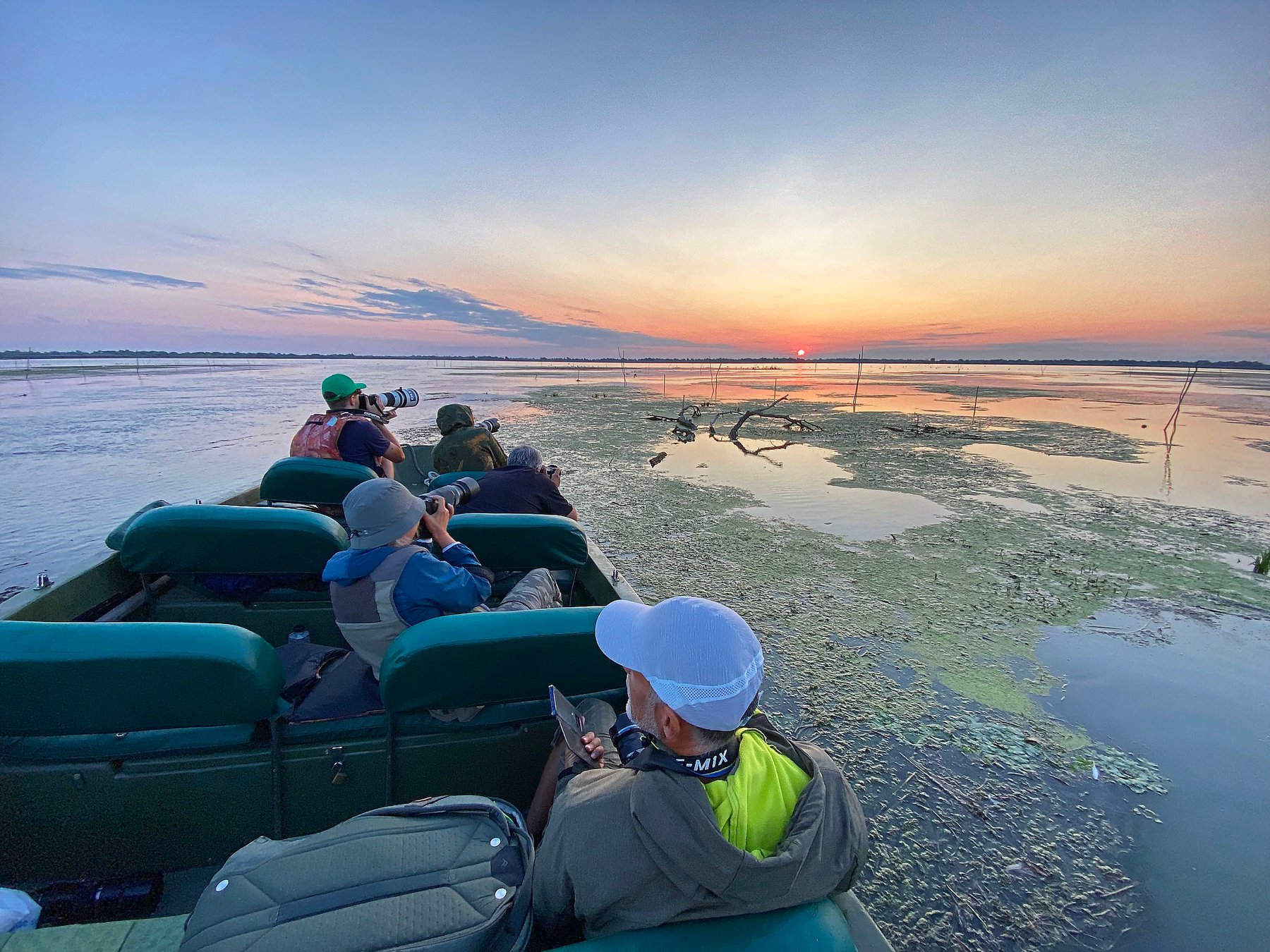 photographers on boat at sunset romania