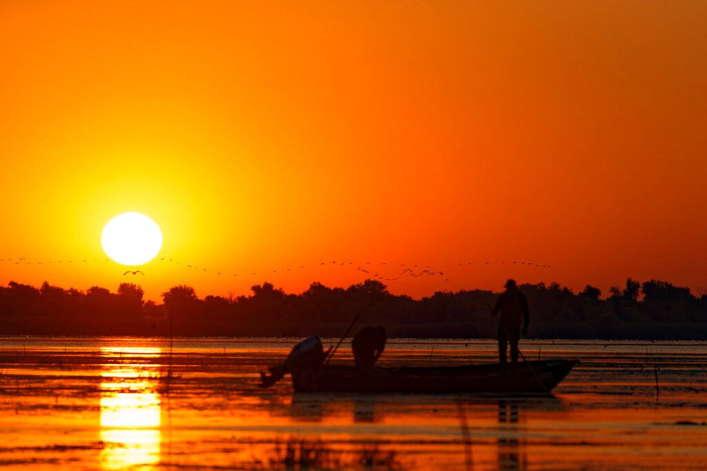 sunset boat silhouette danube delta romania