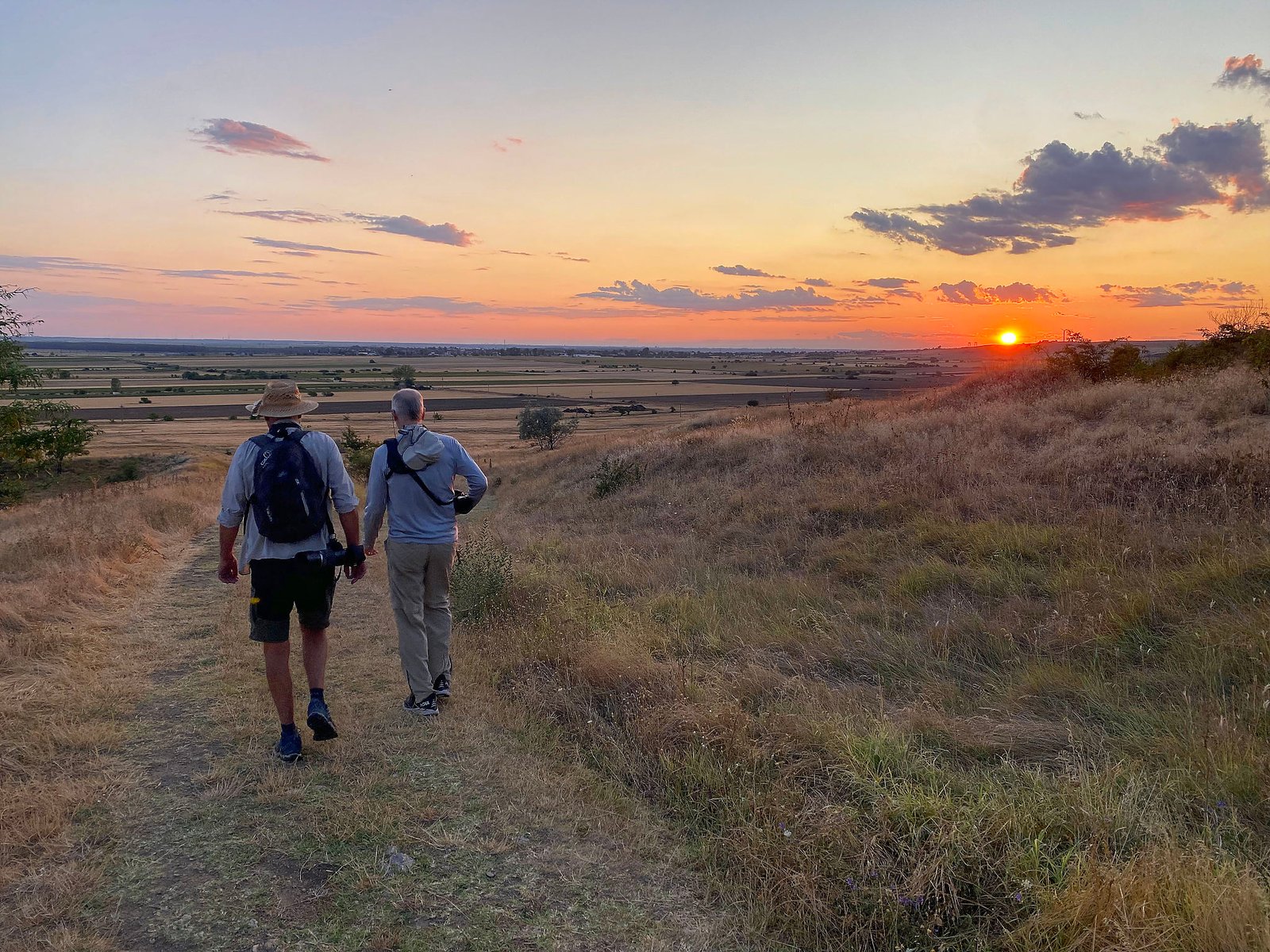 walking at sunset on hillside trail romania