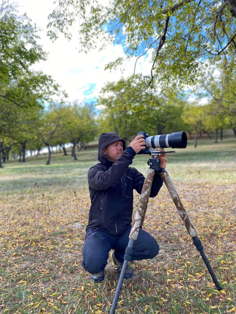 wildlife photographer with telephoto lens romania